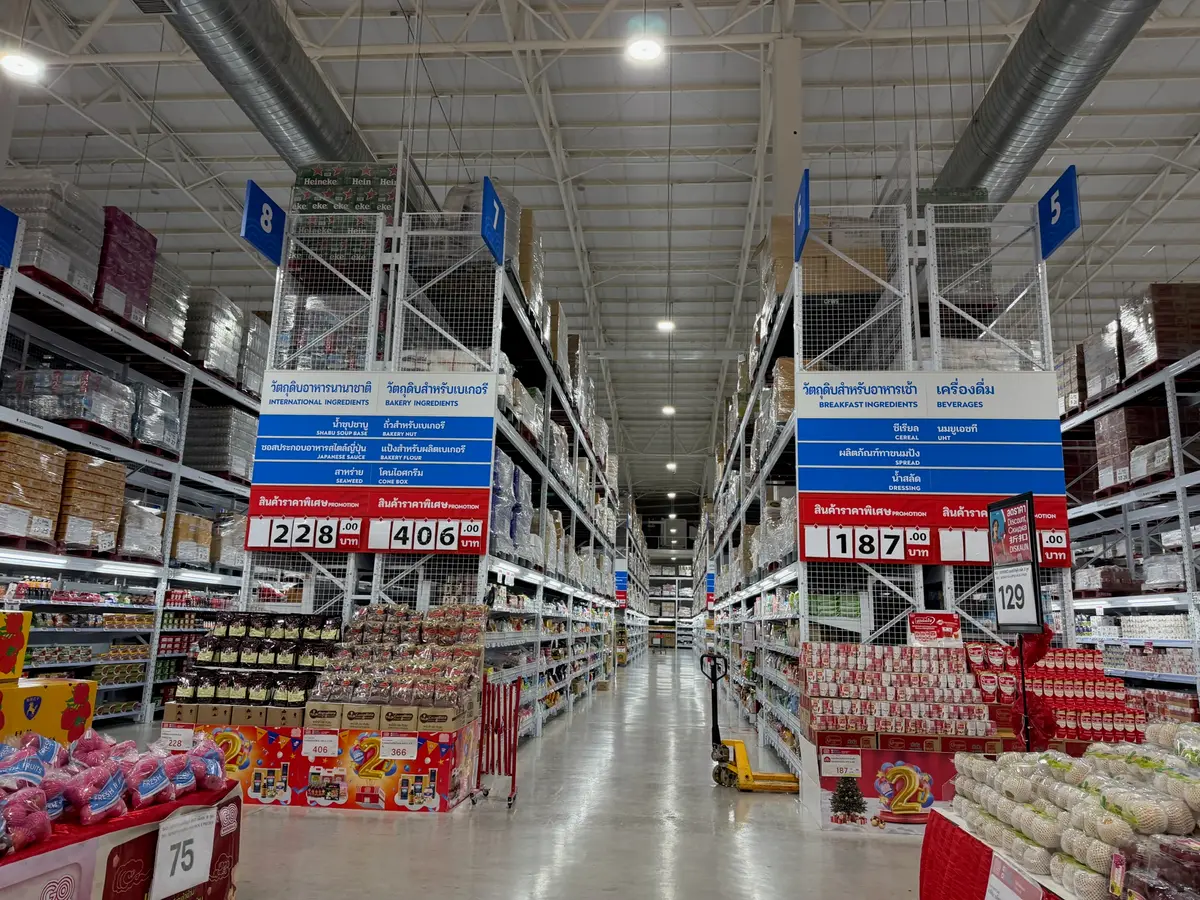 Tall warehouse shelves stacked with boxed goods along a wide aisle.