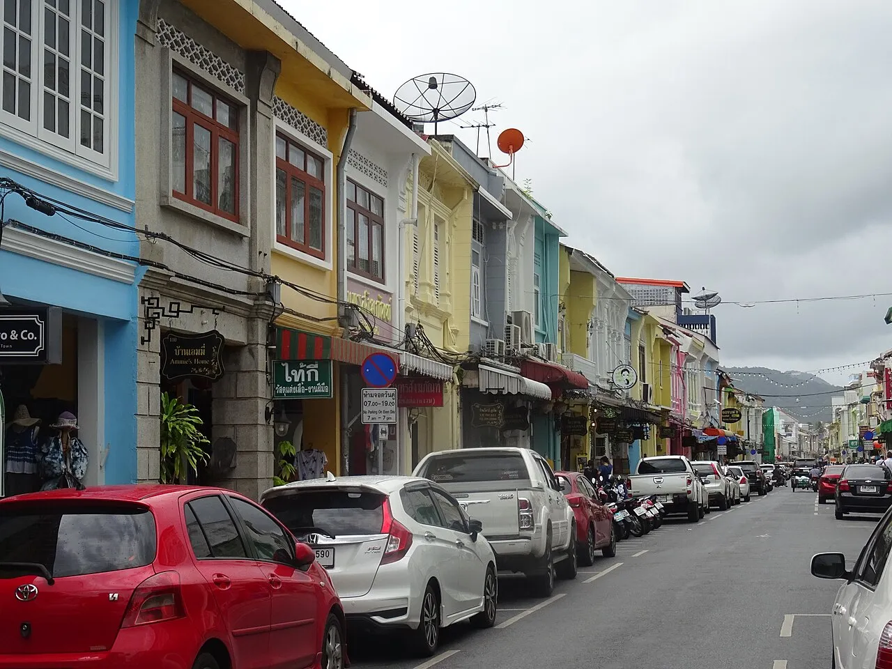 Colourful shophouses and parked cars along Thalang Road in Old Phuket Town