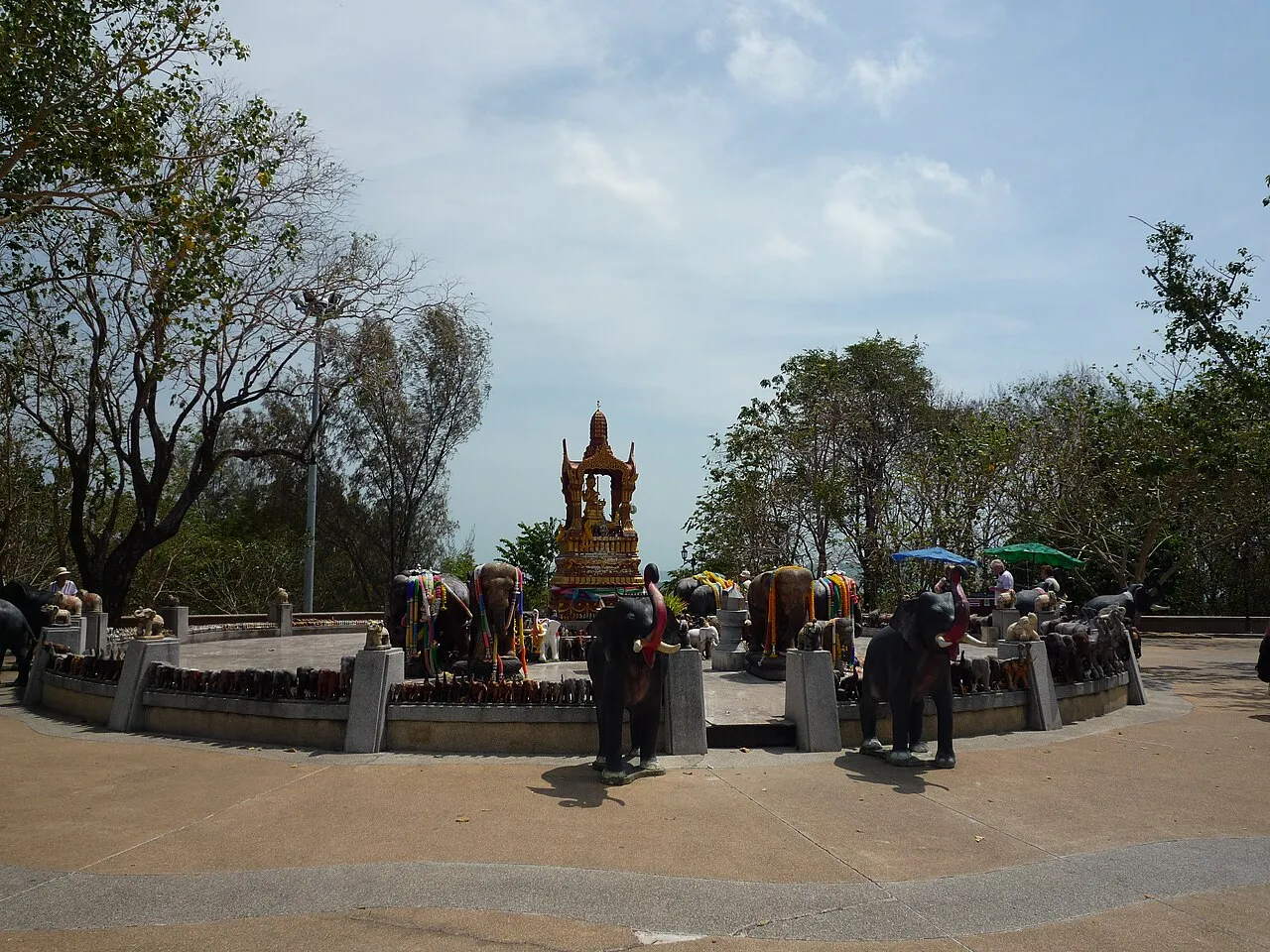 Shrine ringed by elephant statues on a hilltop viewpoint
